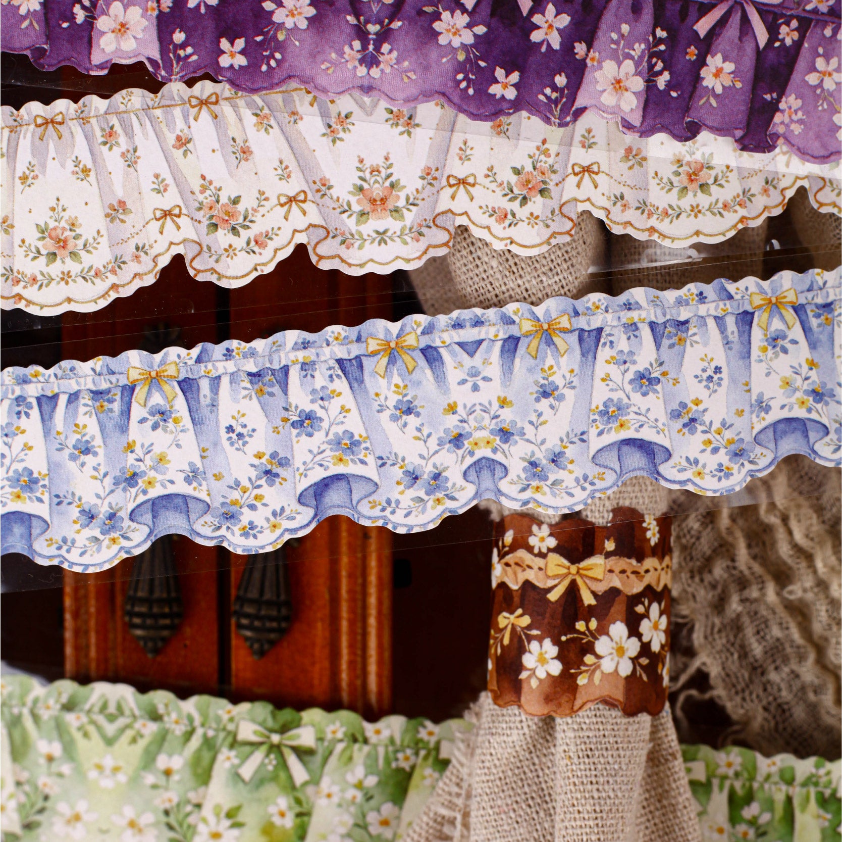 Cloth curtain tape used with stationery for layered scrapbook pages
