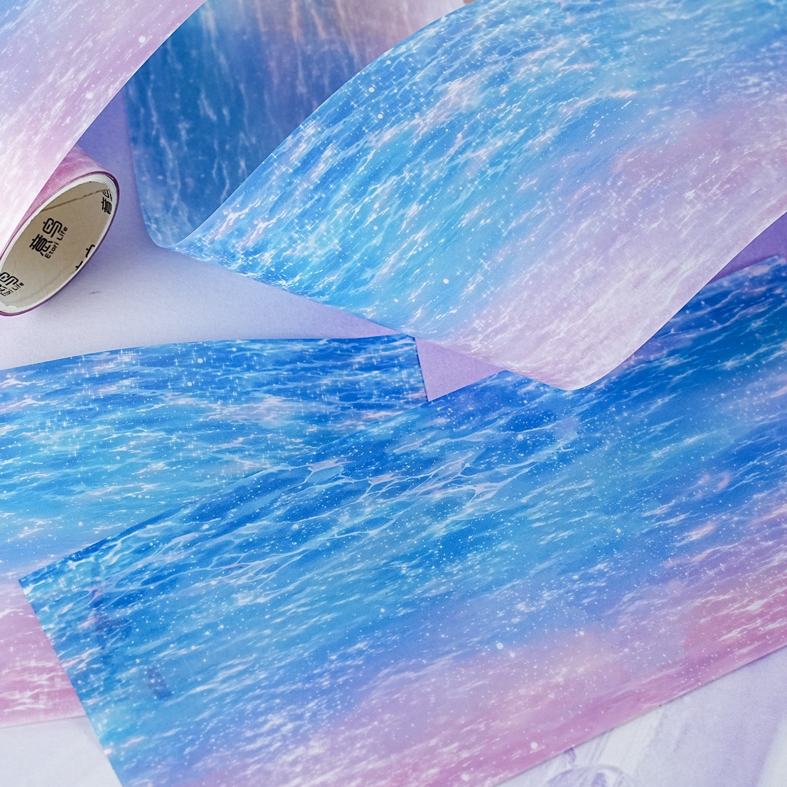 Shimmering water PET tape roll for atmospheric paper crafts